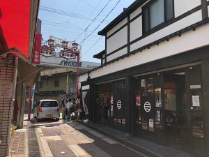 A traditional looking Japanese building with a small shop