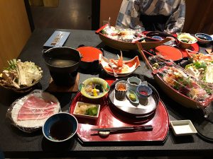 A table with an array of very ornate dishes with various seafood